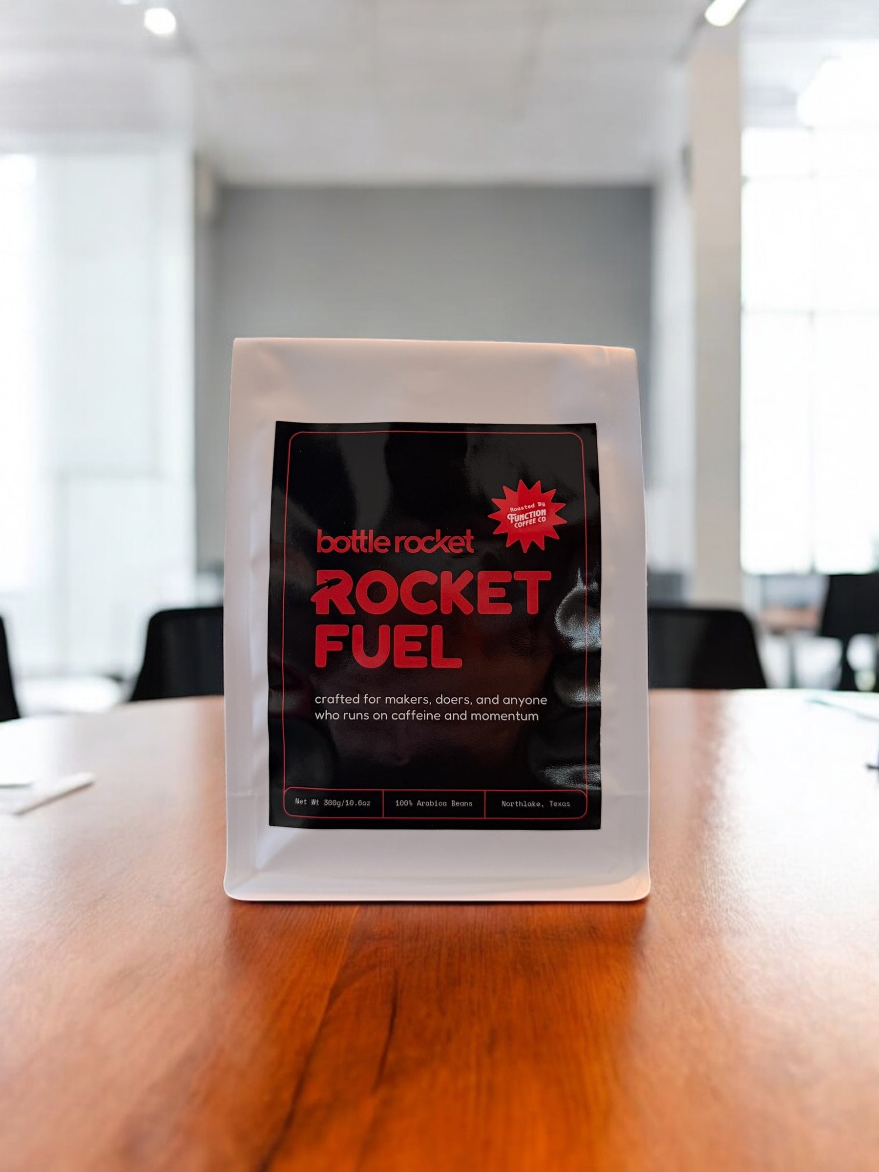 Bottle Rocket Rocket Fuel package on a wooden table in an office setting