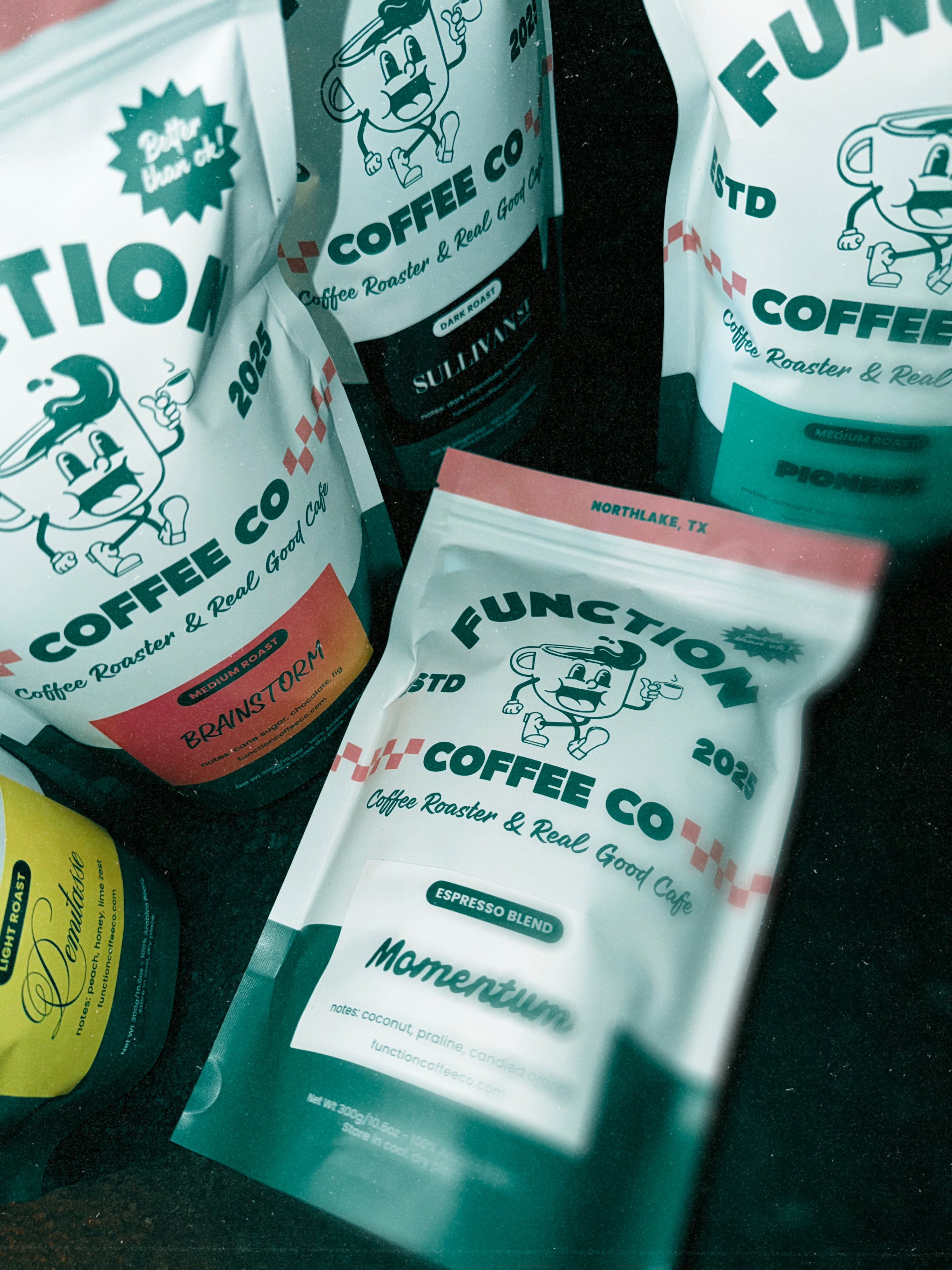 Function Coffee Co packages on a dark surface